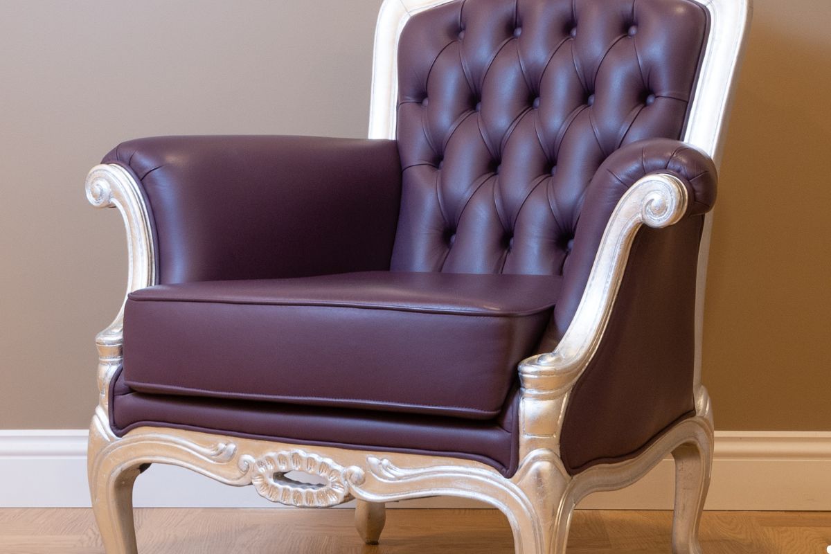 A stylish purple leather chair featuring a sleek silver frame, adding a modern touch to any space.