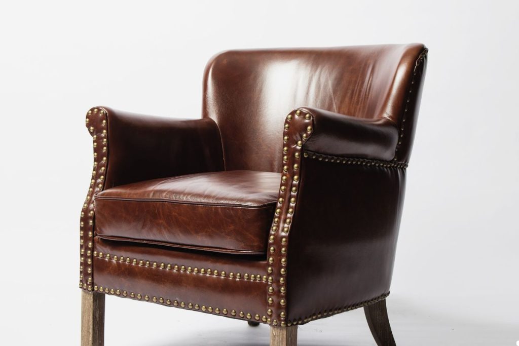 Brown leather chair with a sleek design, showcasing its rich upholstery and elegant craftsmanship.